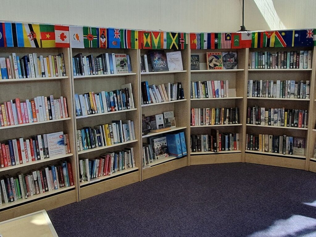 Book shelves with flags, Newquay Library, Cornwall - June 2022