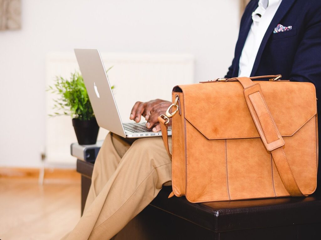 Businessman typing on a laptop (Unsplash)